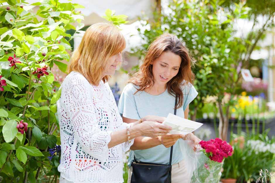 Grower helps visitor at RHS Hampton Court